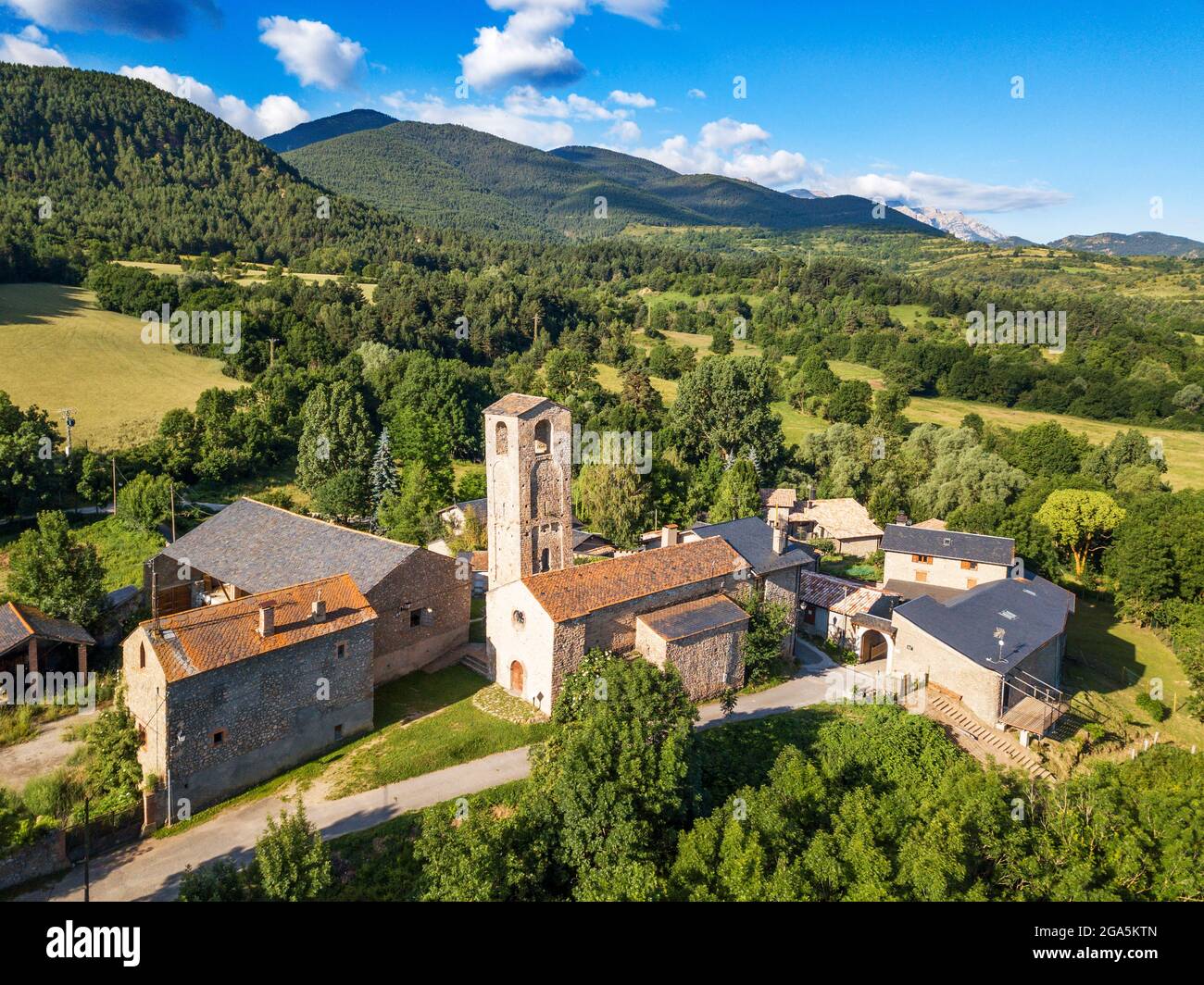 Vue aérienne de l'église de Santa Eugènia de Nerellà à Bellver de Cerdanya Alp Pirineu Lleida province de Catalogne Espagne. Parmi les maisons traditionnelles dans Banque D'Images