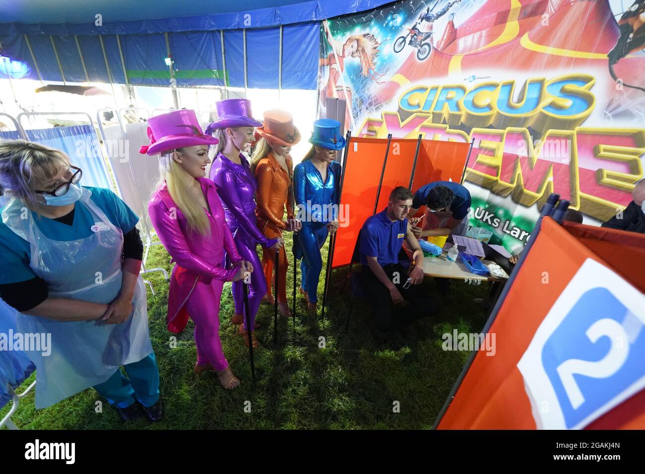 Dre Lisa Pickles, 57 ans (à gauche), responsable clinique du programme de vaccination de Caldove, présente des artistes de Circus Extreme comme leur collegue Ryan Dobie, 24 ans, qui a reçu une vaccination Covid-19 dans une clinique de vaccination pop-up dans le chapiteau du cirque à Halifax. Date de la photo: Samedi 31 juillet 2021. Banque D'Images