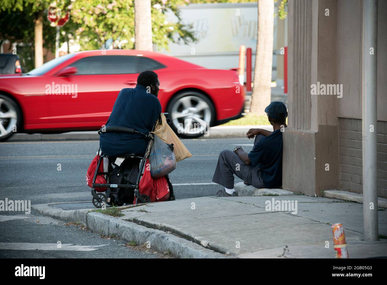 Tampa, Floride, États-Unis. 1er août 2021. Les hommes sans domicile passent le temps le long d'une rue de Tampa dans un quartier à faible revenu, où la toxicomanie et l'alcoolisme et les maladies mentales sont courantes. (Image de crédit : © Robin Rayne/ZUMA Press Wire) Banque D'Images