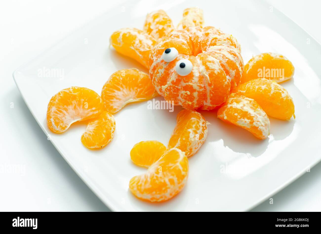 Crabe de fruits, une collation faite de parties fraîches de mandarines servies en forme de crabe, nourriture amusante Banque D'Images