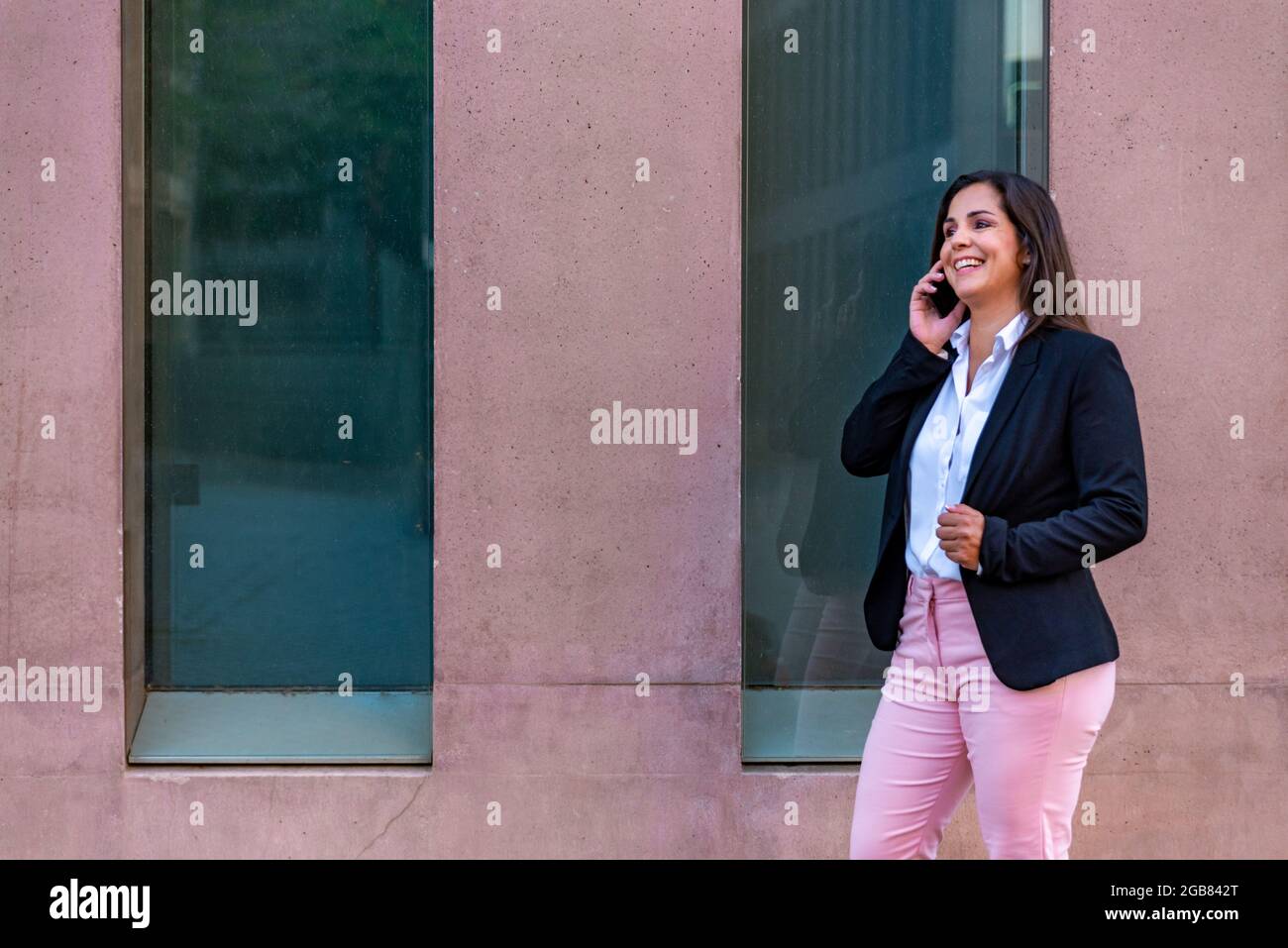 Femme d'affaires caucasienne avec téléphone mobile dans la ville Banque D'Images