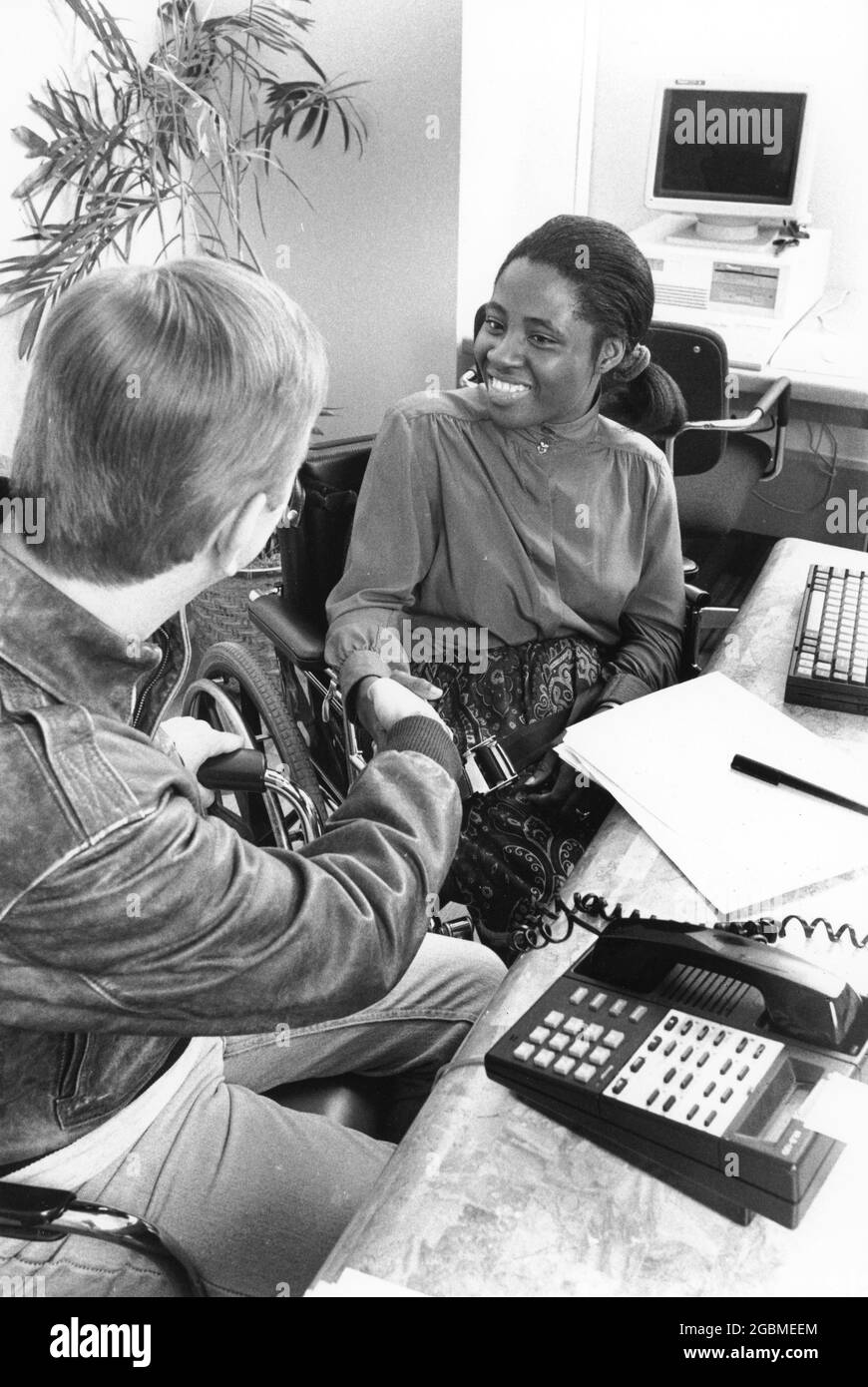 Austin Texas USA, vers 1994: Handicapé Black Woman, fin 20, rencontre avec le client dans son bureau. ©Bob Daemmrich Banque D'Images