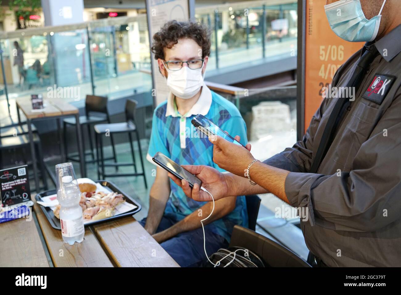 Vérification positive du passage vert sur le smartphone, requise pour les tables intérieures dans les restaurants et les bars. Turin, Italie - août 2021 Banque D'Images