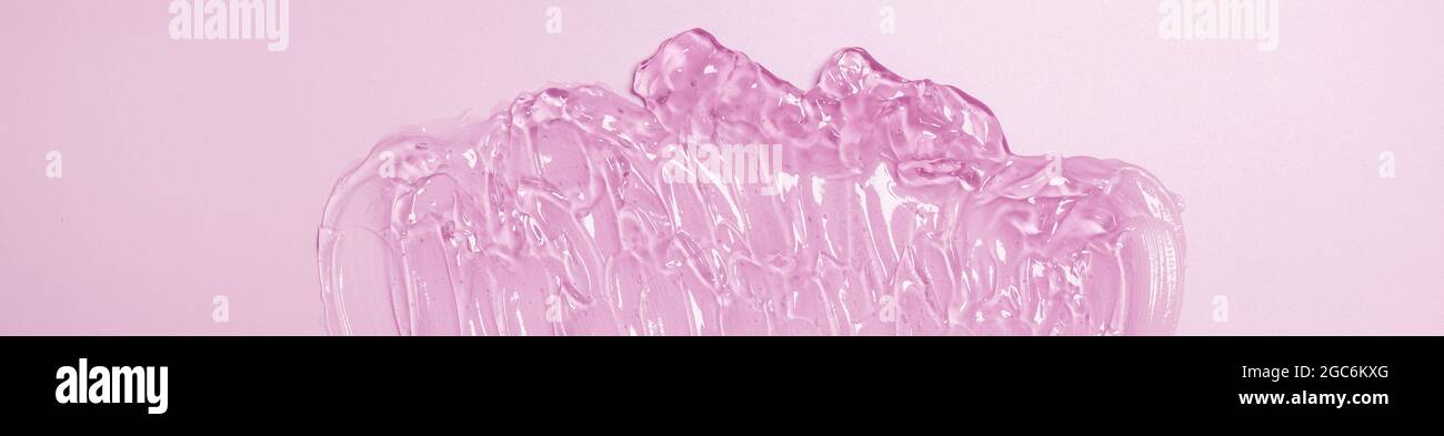 Liquide gel cosmétique taches rose orange fond. Protection contre les virus ou concept cosmétique Banque D'Images