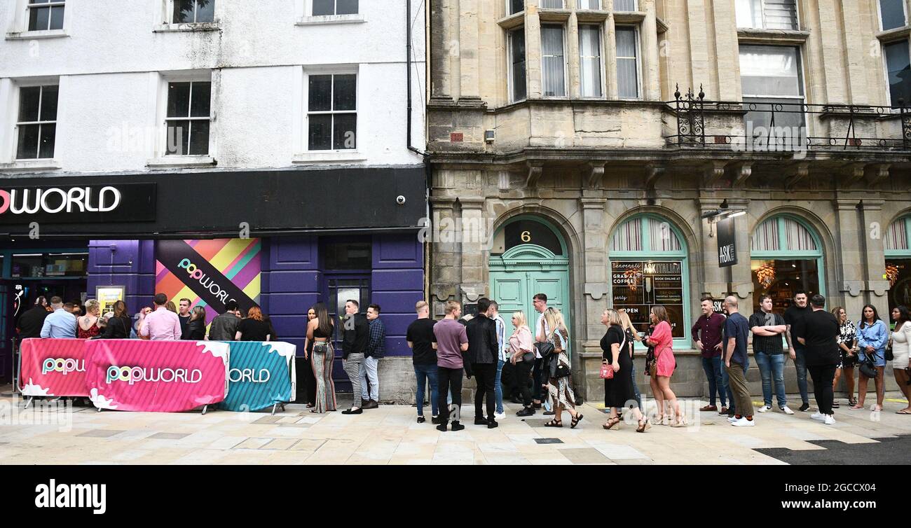 Les amateurs de clubs font la queue devant Popworld sur Wind Street à Swansea, le samedi soir, tandis que des boîtes de nuit s'ouvrent à travers le pays de Galles pour la première fois depuis le début de la pandémie, et que la restriction du masque de visage n'est plus obligatoire dans les pubs. Banque D'Images