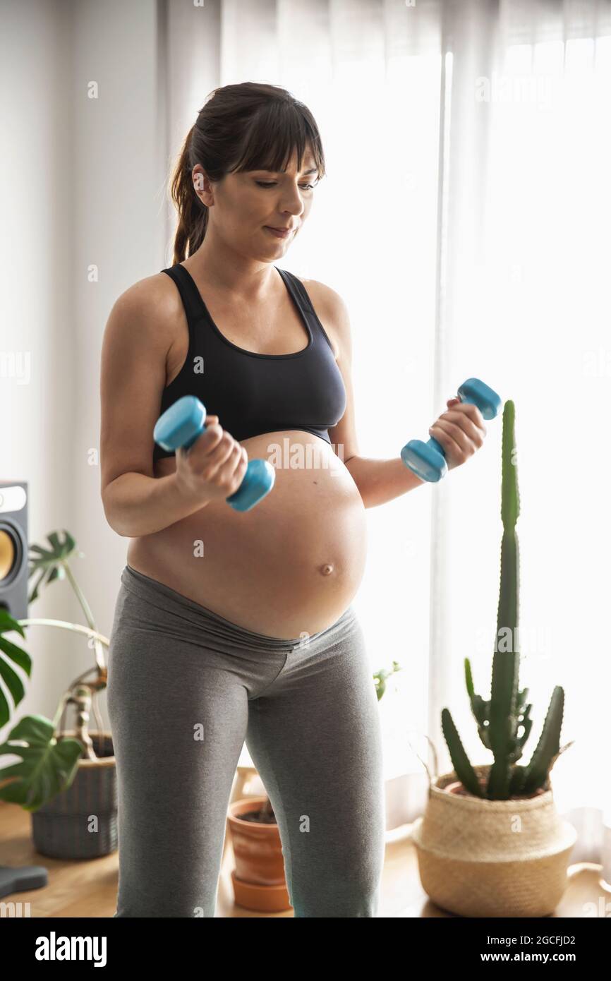 Femme enceinte faisant des exercices à la maison Banque D'Images