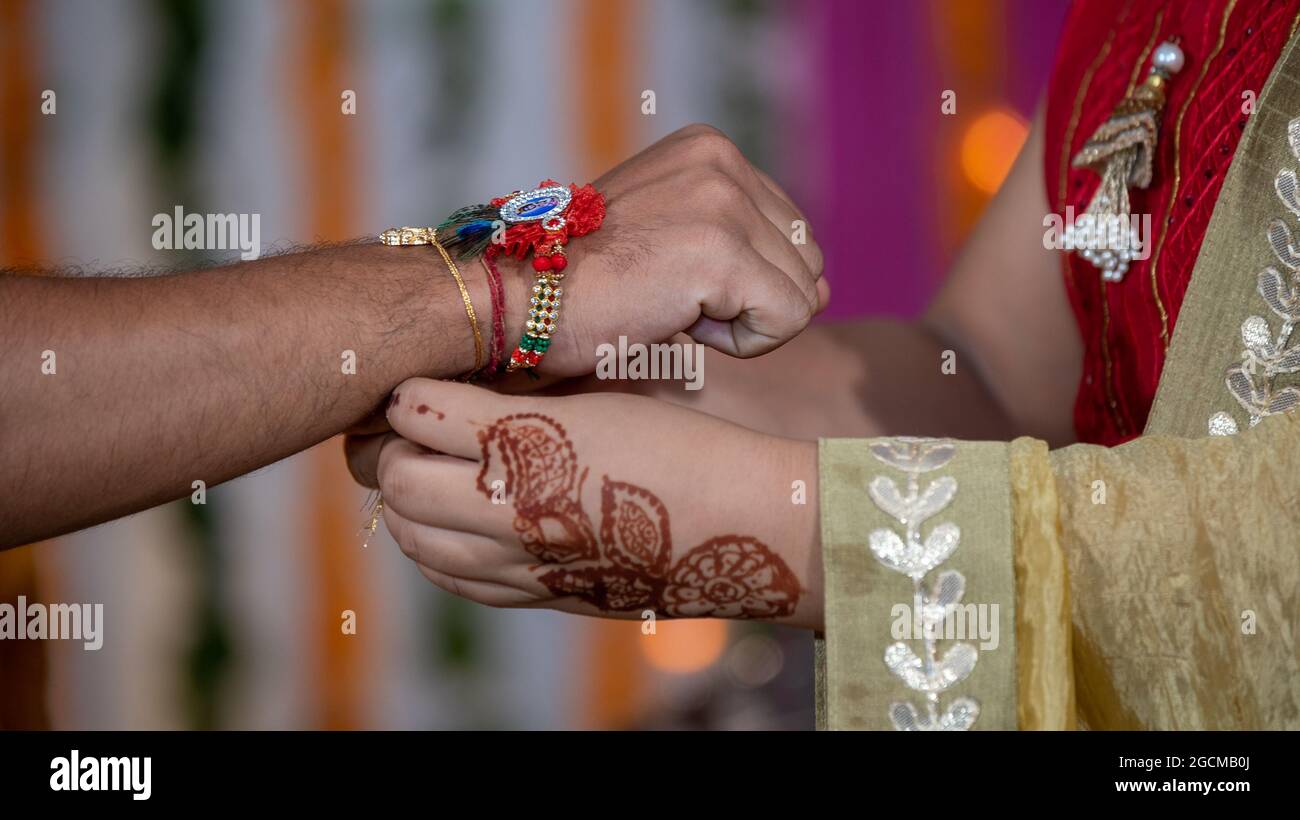 Sœur attachant le rakhi, Raksha Bandhan au poignet du frère pendant le festival ou la cérémonie - Raksha Bandhan a célébré dans toute l'Inde comme un amour ou une relation désintéressée entre frère et sœur Banque D'Images