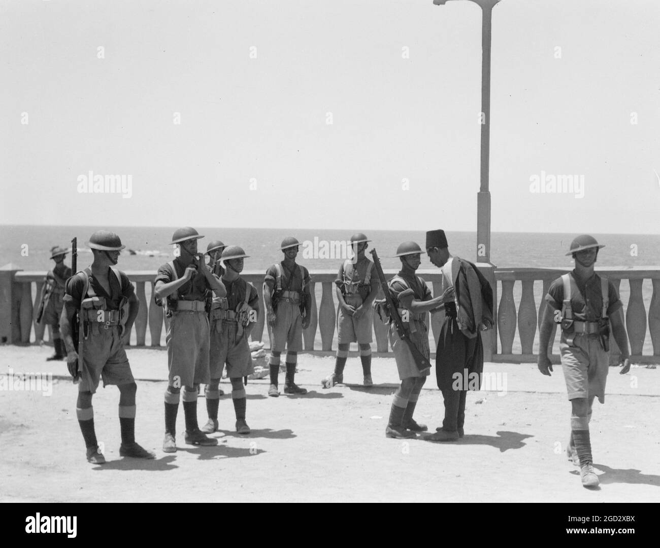 Perturbations palestiniennes 1936 : le long du front de mer de Jaffa, les citoyens palestiniens sont fouillés par des soldats ca. 1936 Banque D'Images