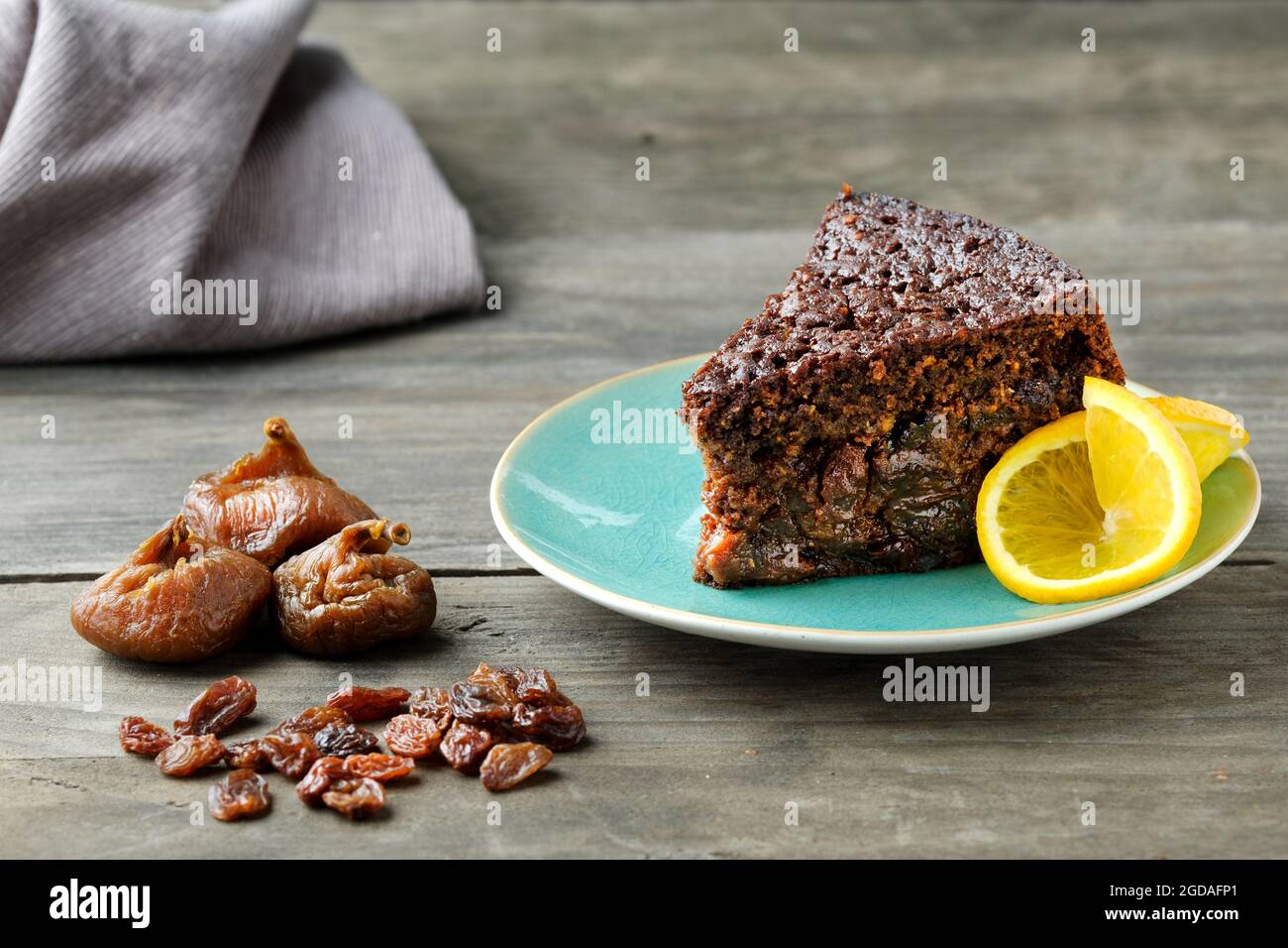 Une tranche d'orange maison, chocolat, gâteau aux fruits fait à l'aide d'une recette de Nigella Lawson. Le gâteau humide est décoré de tranches d'orange frais Banque D'Images