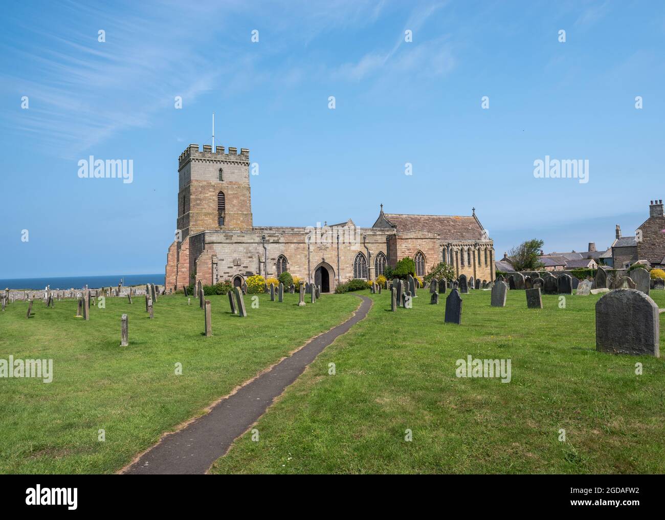 Bamburgh, Northumberland, Royaume-Uni, 21 juillet 2021 - Eglise St Aidens et cimetière le jour ensoleillé avec ciel bleu. Banque D'Images