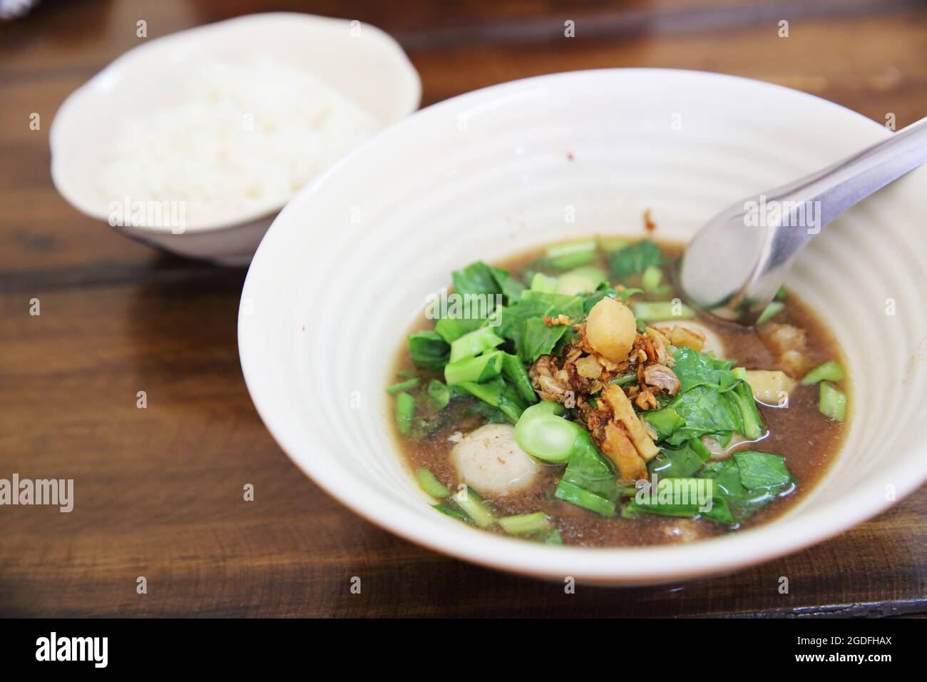 Nouilles avec soupe de bœuf sur fond de bois Banque D'Images