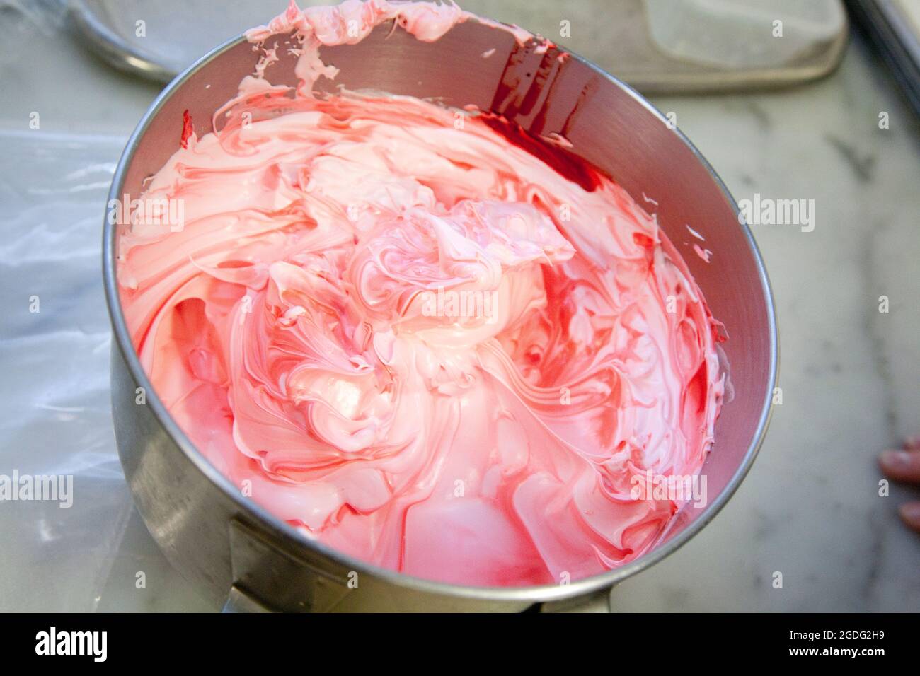 Le blanc d'oeuf rose forme la base pour les macarons de fraise. Banque D'Images