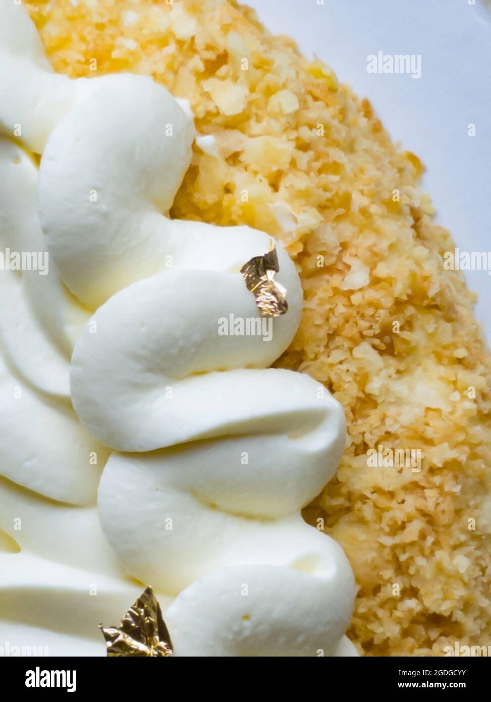 Gâteau Napoléon en gros plan avec ganache au chocolat blanc et or comestible Banque D'Images