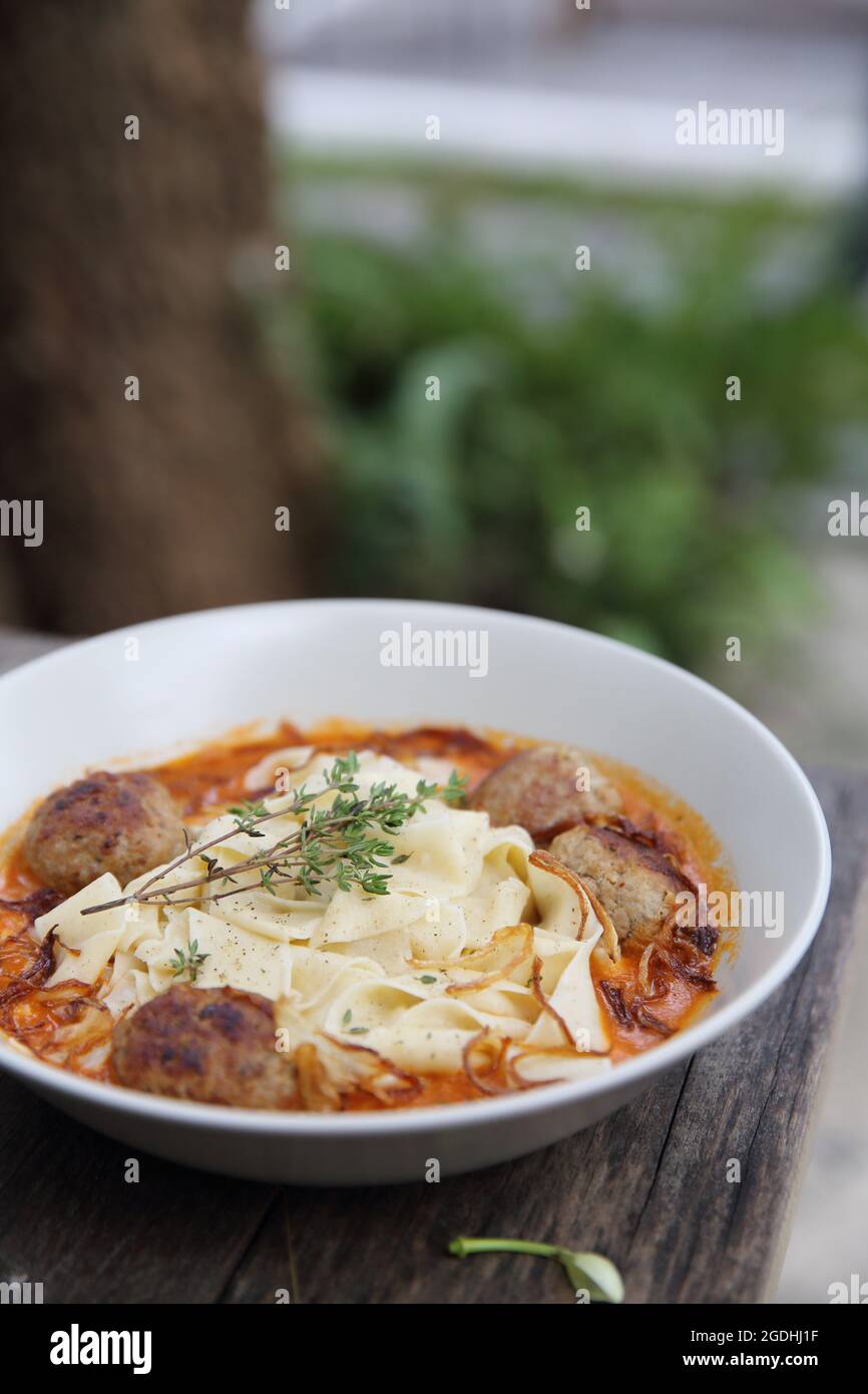 Boulettes de pâtes sauce tomate sur fond de bois Banque D'Images