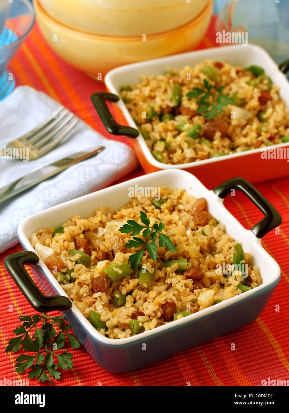 Riz, quinoa et bulgur avec légumes verts et raisins secs français. Banque D'Images