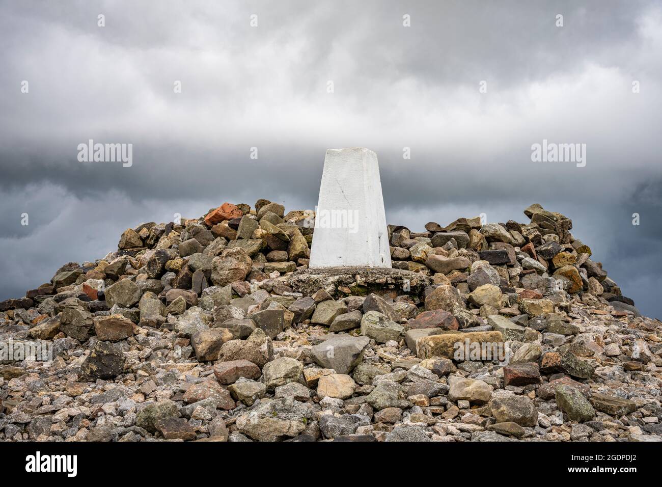 Pilier de triangulation (point de triangulation) et cairn au sommet de Windy Gyle sur la frontière de l'Angleterre en Écosse dans les collines de Cheviot, Northumberland. Banque D'Images