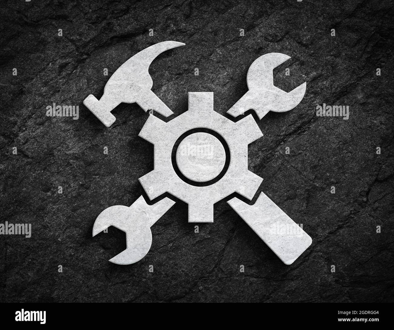 Symbole de construction ou d'entretien avec une clé à engrenages et un symbole de marteau sur fond de mur en pierre sombre Banque D'Images