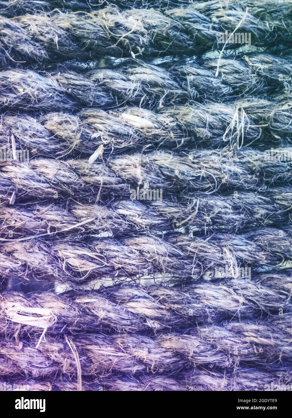 Fond texturé bleu dégradé fait de mer tordue, cordes de jute. Écharpes de texture maritime vintage. Arrière-plan des cordes de bateau Banque D'Images