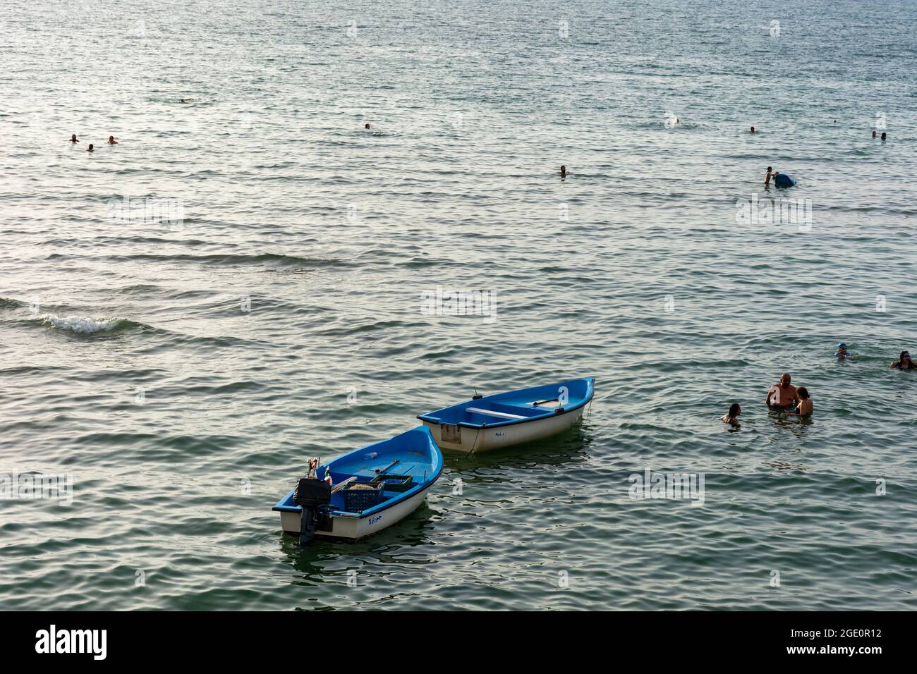 Vue aérienne de deux bateaux flottant sur l'eau, et les personnes nageant sur la plage, Skikda, Algérie. Banque D'Images