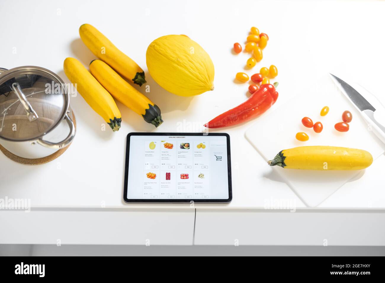 Légumes frais et table numérique avec le site Web de la boutique en ligne sur la table blanche Banque D'Images