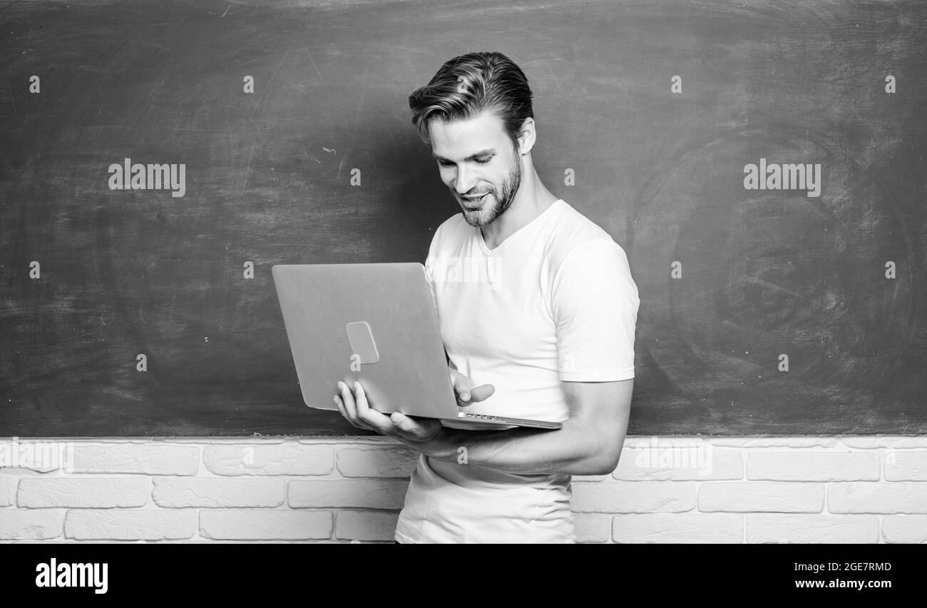 Communications en ligne. Professeur d'école avec ordinateur portable. Le beau homme utilise la technologie moderne. Technologie numérique. Programmation développement web. Numérique Banque D'Images