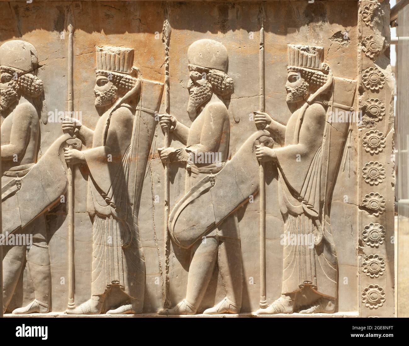 Soldats de l'empire historique avec armes en mains. Bas-relief en pierre dans la ville ancienne de Persepolis, Iran. Capitale de l'Empire des Achaéménides (550 - 330 av. J.-C.) Banque D'Images