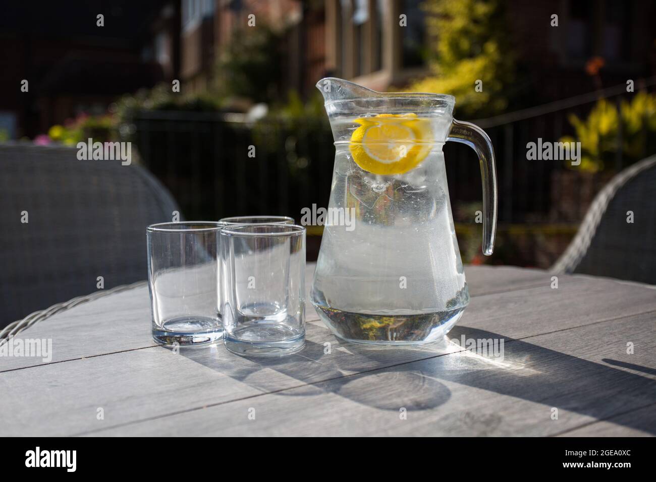 Verseuse d'eau rafraîchissante avec tranches de fruits et deux verres Banque D'Images