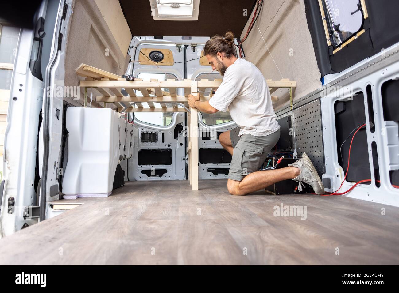 Homme travaillant à l'intérieur de sa camionnette de camping Banque D'Images