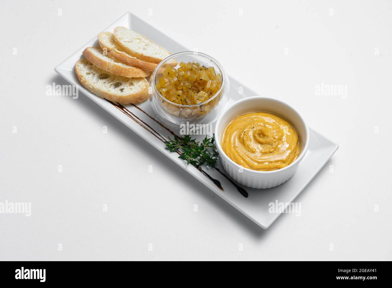 gros plan du pâté de foie d'oie avec des chutneys de pomme et du pain sur fond blanc Banque D'Images