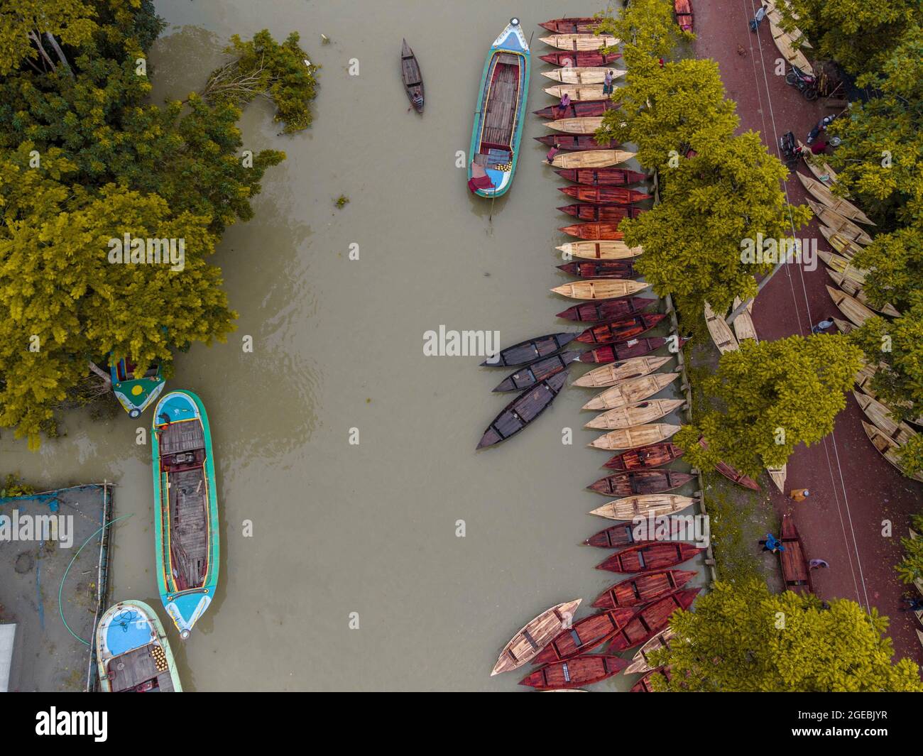 Barishal (Bangladesh), le 18 août 2021 : vue aérienne des constructeurs de bateaux fabriquent des bateaux en bois à «Noukar Haat» (marché de bateaux) à Kuriana, sous la section Swarupkathi upazila de Pirojpur. Le marché de Noukar Haat, d'une longueur de deux kilomètres, est réputé pour le commerce de différentes variétés de bateaux pendant la saison de la mousson. Le marché se déroule tous les vendredis de mai à novembre. “Panis” ou “Pinis”, “Dingi” et “Naak Golui” sont les types de bateaux disponibles à la vente, construits par des artisans locaux des Muktahar, Chami, Boldia, Inderhaat, Boitha Kata, Villages de Dubi et Kathali. Crédit: M Banque D'Images