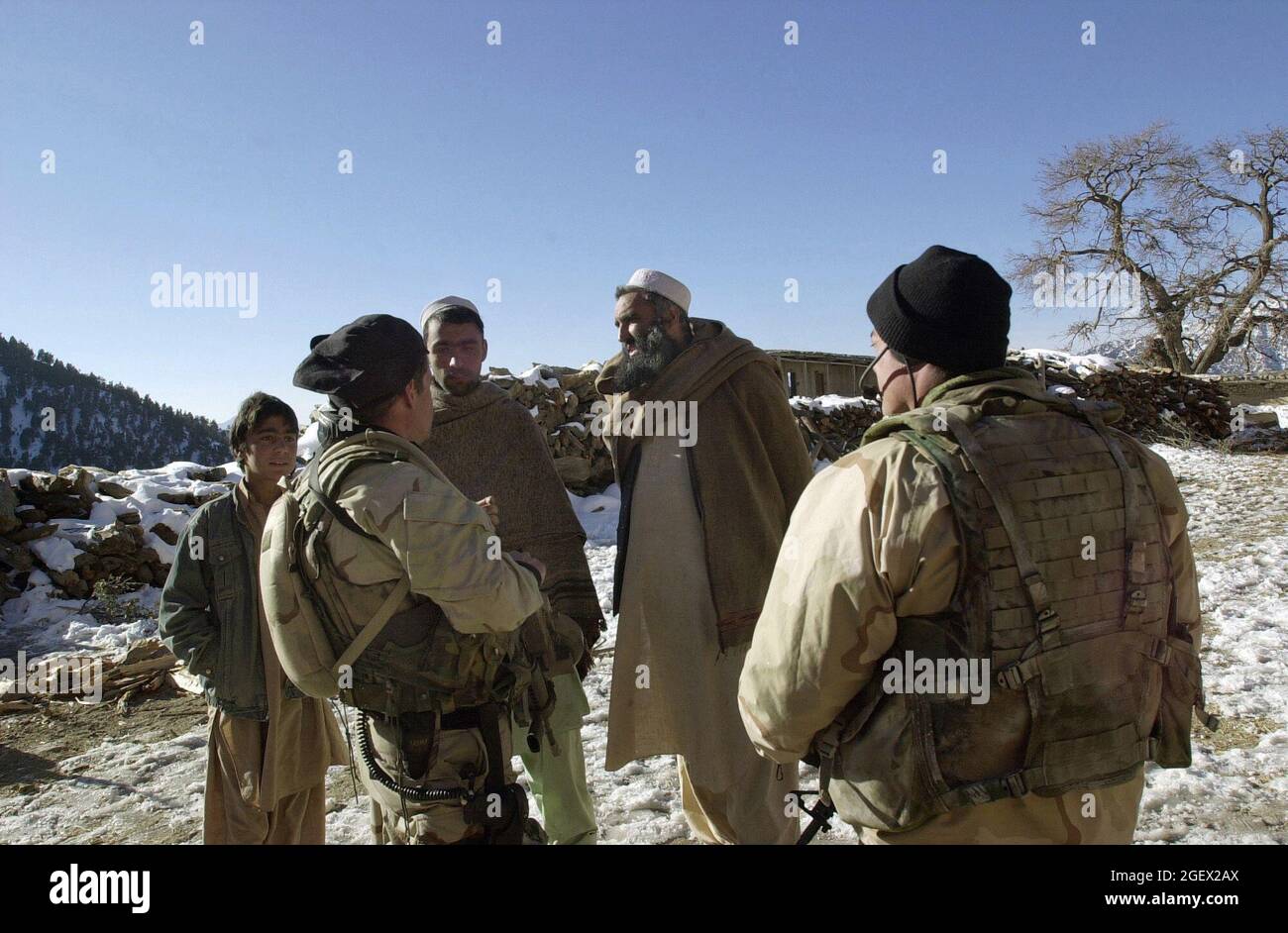 U.S. Navy Seals s'entretient avec les Afghans locaux lors d'une mission d'exploitation de sites sensibles dans les montagnes Jaji, le 12 janvier 2002. Opérations spéciales de la Marine les Forces d'opérations spéciales effectuent des missions en Afghanistan à l'appui de l'opération Enduring Freedom. (É.-U. Photo de la marine par Tim Turner, maître de 1re classe) Banque D'Images