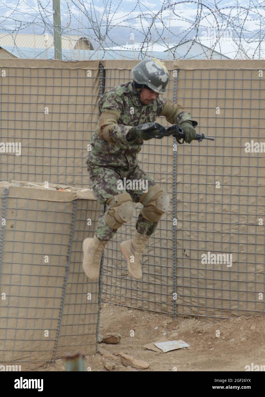 Province de PAKTYA, Afghanistan – un stagiaire de base de l’Armée nationale afghane saute d’une barrière lors d’un cours d’obstacles au Centre régional d’instruction militaire de Gardez, le 25 février 2013. Le cours de formation de base de neuf semaines en est à la sixième semaine d'enseignement et sera diplômé de près de 600 nouveaux soldats de l'ANA à la fin du mois de mars 2013. (É.-U. Photo de l'armée par la SPC. Tianna Waite, 115e Détachement mobile des affaires publiques) Banque D'Images