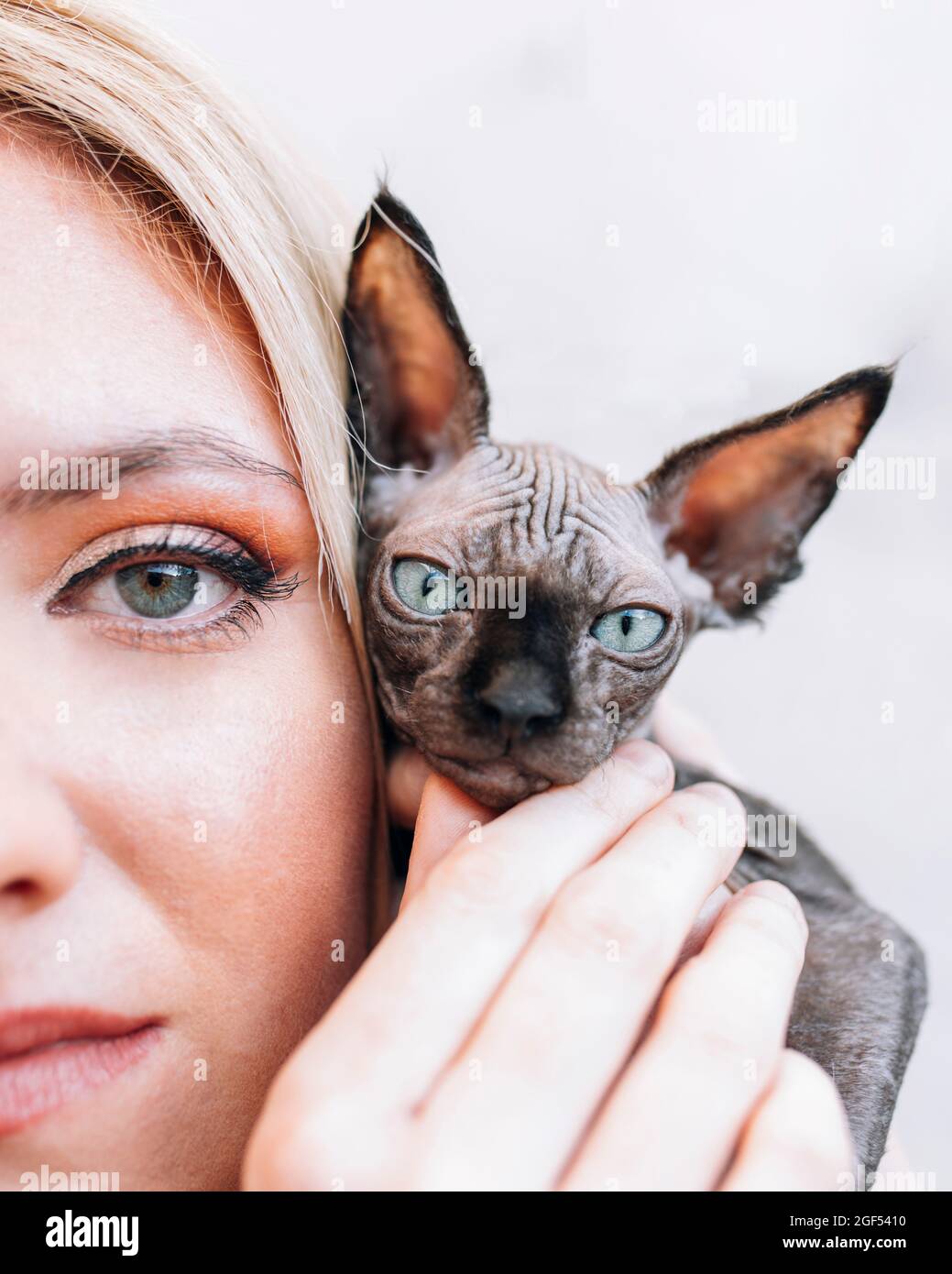 Femme tenant chaton par le visage Banque D'Images
