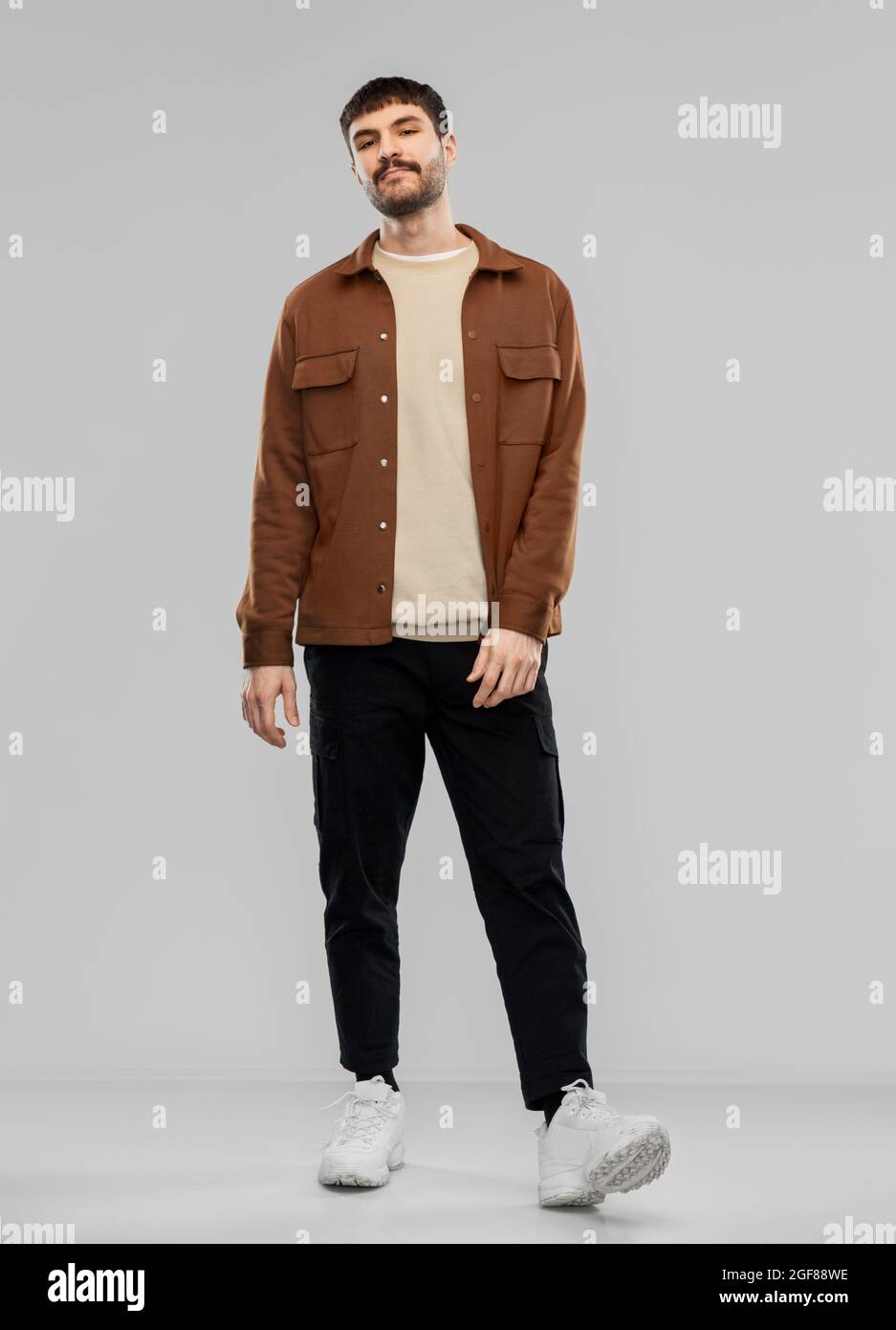 jeune homme en veste marron et pantalon noir Photo Stock - Alamy