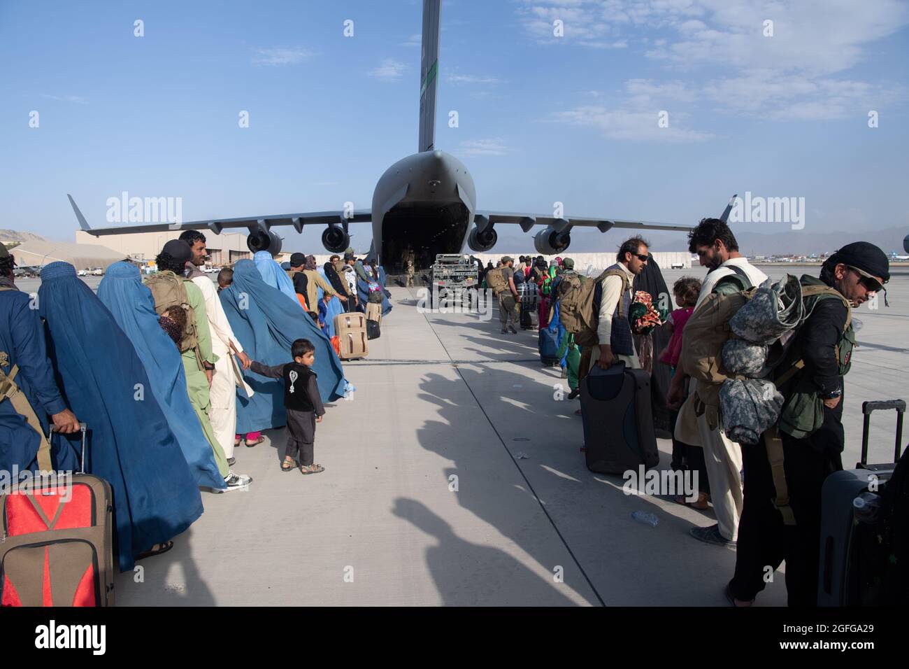 Les pilotes et les charmeurs de la Force aérienne américaine affectés au 816e Escadron de transport aérien expéditionnaire, chargent des passagers à bord d'un C-17 Globemaster III de la Force aérienne américaine à l'appui de l'évacuation en Afghanistan à l'aéroport international Hamid Karzaï (HKIA), en Afghanistan, le 24 août 2021. (É.-U. Photo de la Force aérienne par le Sgt. Donald R. Allen) Banque D'Images