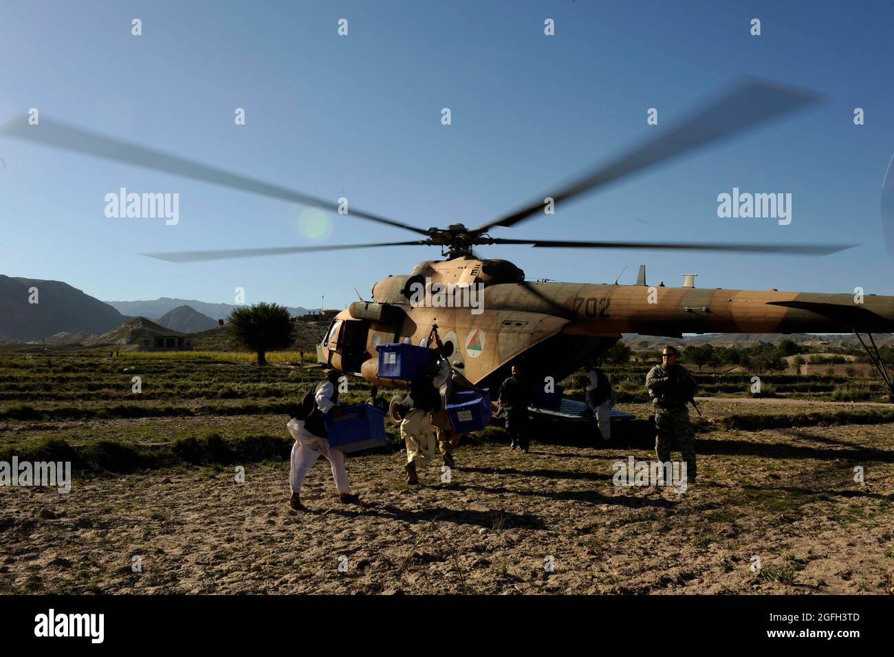 Les Afghans et UN équipage de l'armée de l'air américaine du Commandement de l'entraînement aérien de l'OTAN en Afghanistan chargent des boîtes de bulletins électoraux sur un hélicoptère MI-17 près de Kaboul, en Afghanistan, le 21 septembre 2010. (É.-U. Photo de la Force aérienne/Sgt. Eric Harris) (PUBLIÉ) Banque D'Images
