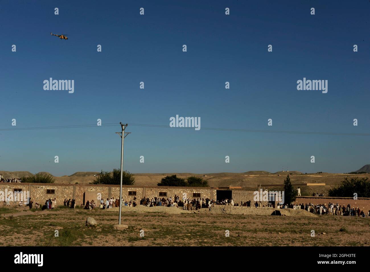 Les Afghans observent que des boîtes de bulletins de vote sont chargées sur un hélicoptère MI-17 près de Kaboul, en Afghanistan, le 21 septembre 2010. (É.-U. Photo de la Force aérienne/Sgt. Eric Harris) (PUBLIÉ) Banque D'Images