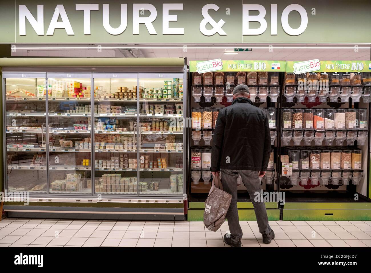 Supermarché Super U : homme au milieu de la section d'aliments biologiques, articles en vrac, épicerie Banque D'Images