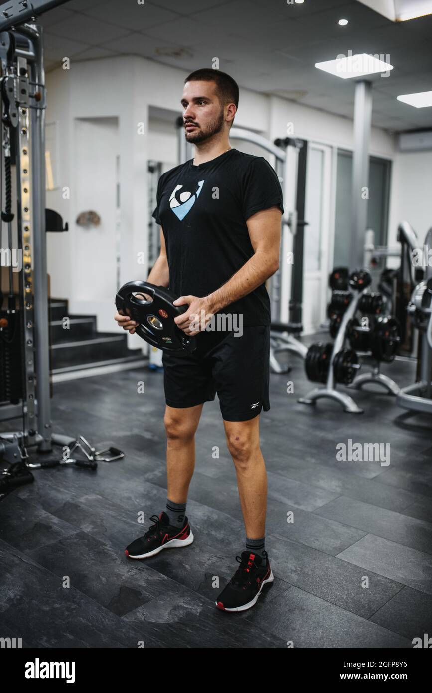 Jeune homme élégant dans des vêtements de sport s'entraîner dans une salle  de sport Photo Stock - Alamy