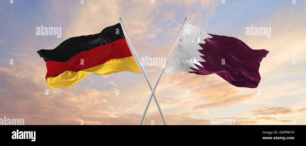 Drapeaux de l'Allemagne et du Qatar agitant dans le vent sur les mâts