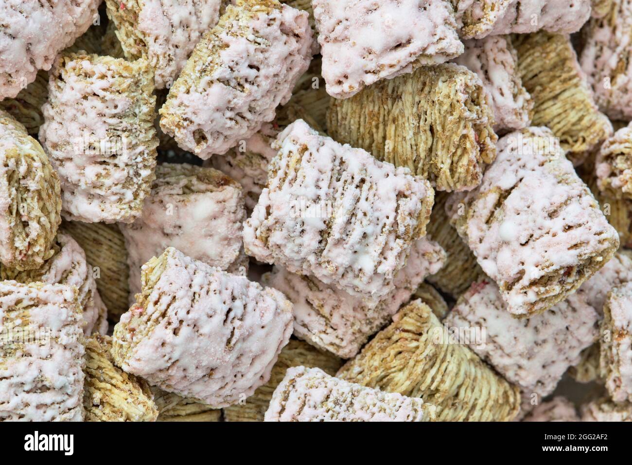 Biscuits de blé déchiquetés céréales de petit déjeuner avec arôme de fraise sans lait, gros plan directement au-dessus. Banque D'Images