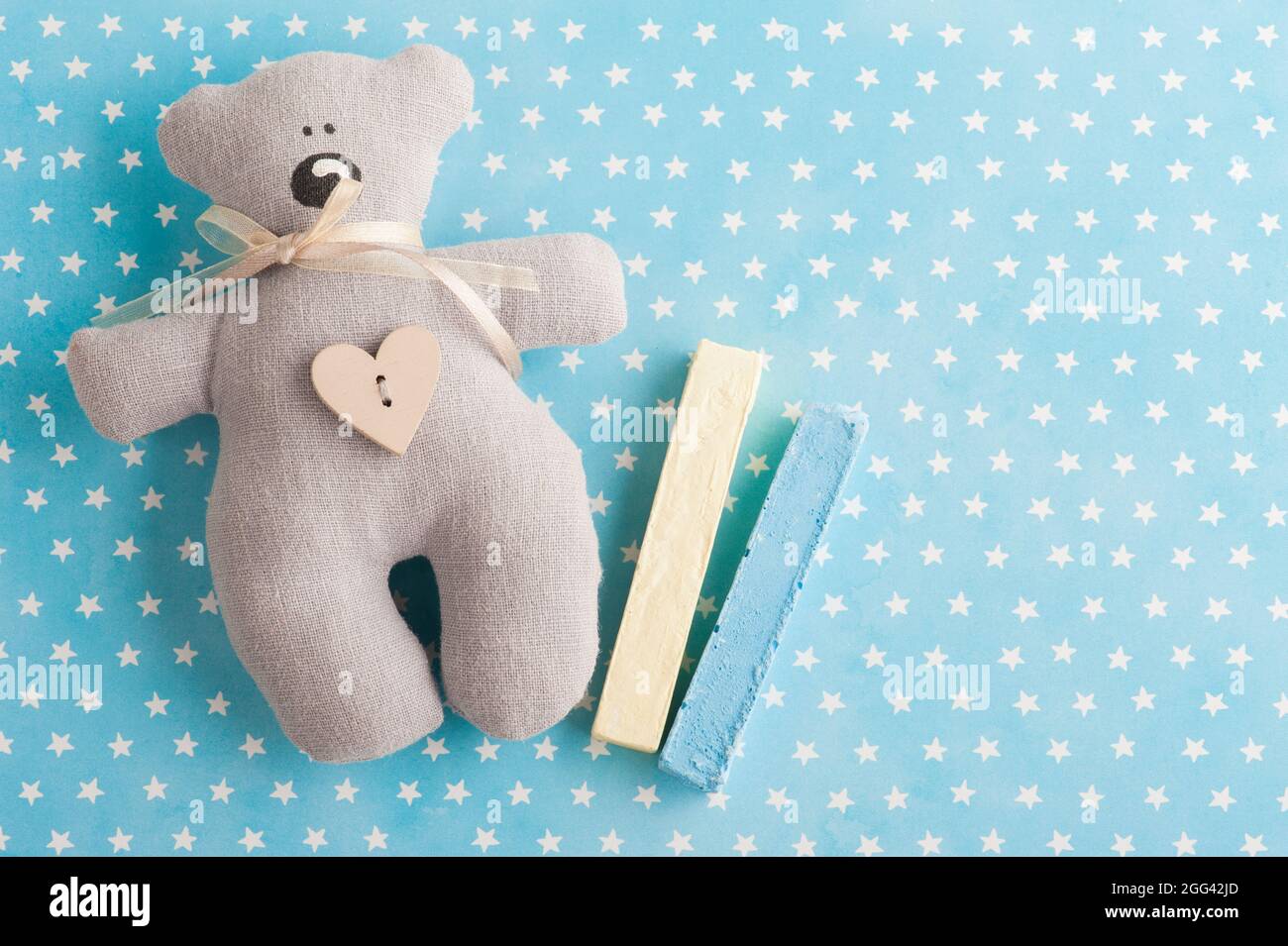 Fond bleu blanc étoiles avec ours en peluche et craie. Invitation à une fête de douche de bébé, vue du dessus Banque D'Images
