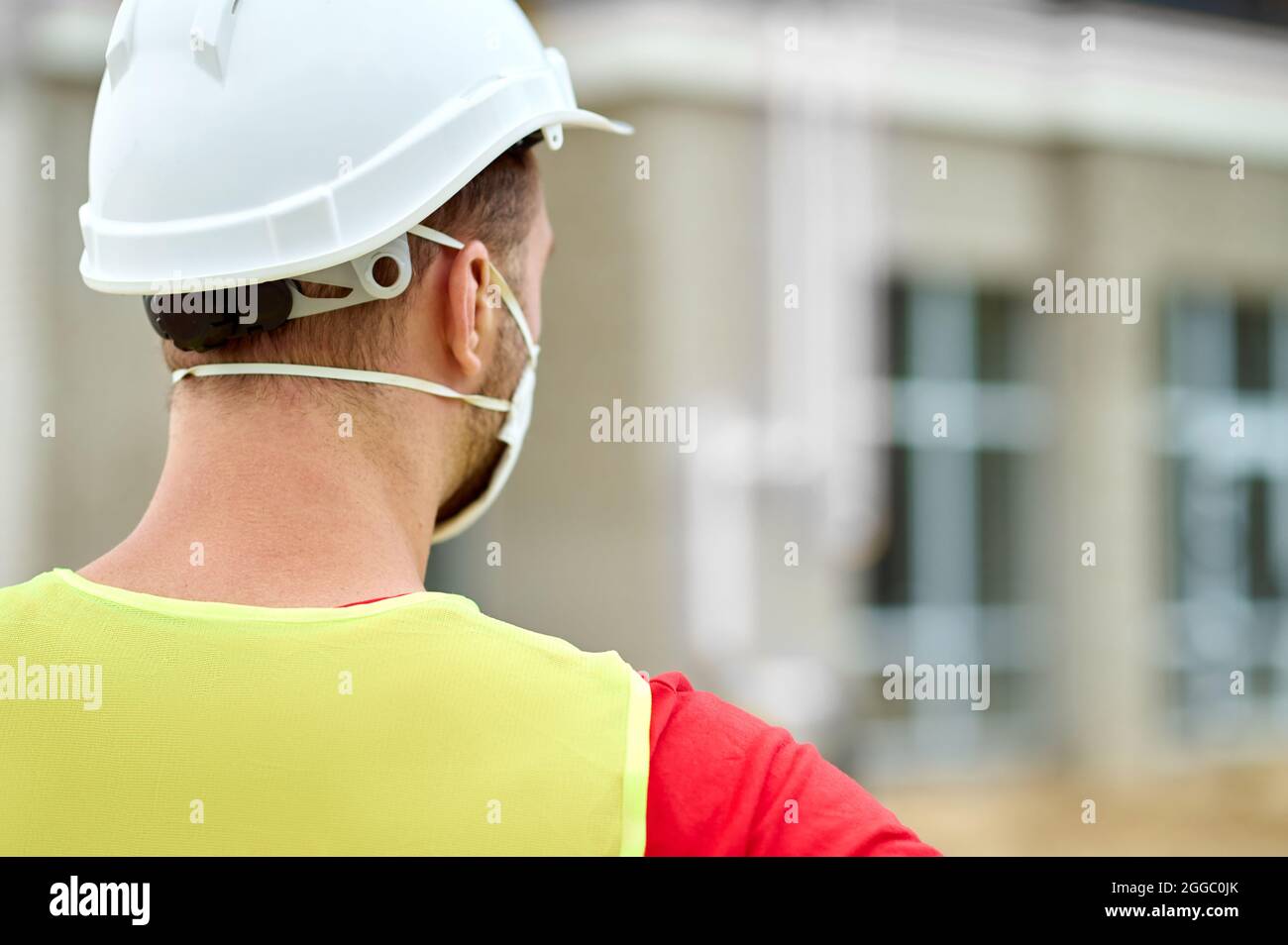 Homme caucasien à poil sombre examinant un nouvel objet de construction Banque D'Images