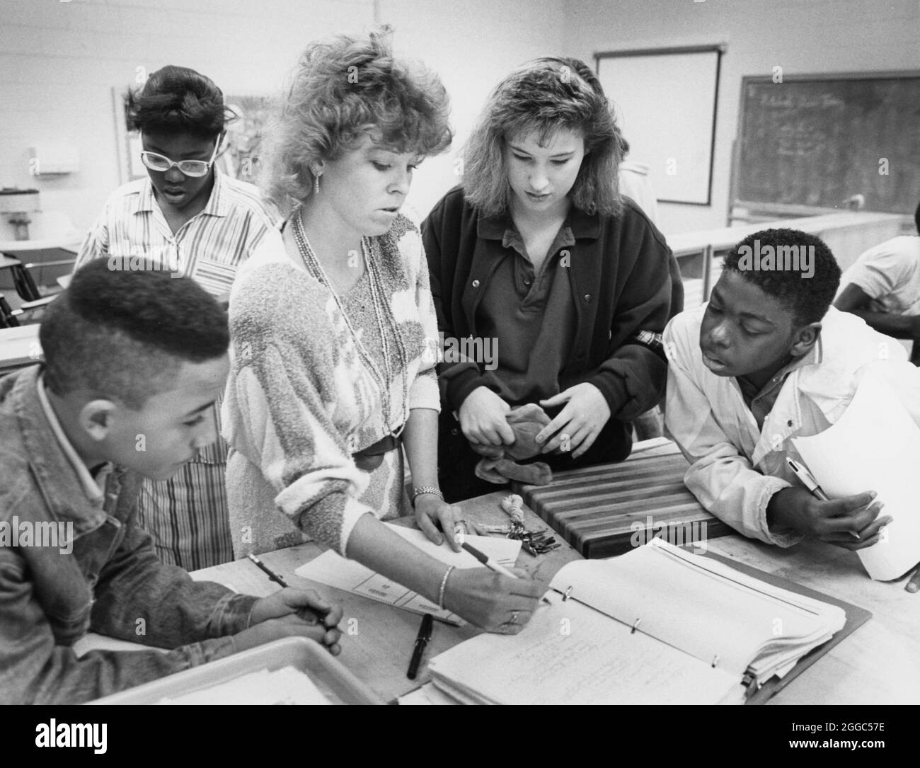 Austin Texas USA, circa 1992 : les étudiants noirs et anglo regardent comme une enseignante de magasin coordonne le projet au Kealing Junior High. ©Bob Daemmrich Banque D'Images
