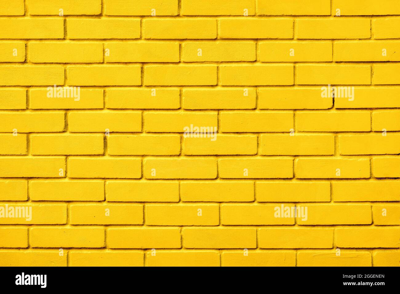 Briques peintes motif de couleur jaune mur arrière-plan blocs. Design naturel texture fond jaune brique mur couleur peinture bloc motif. Bloc Banque D'Images