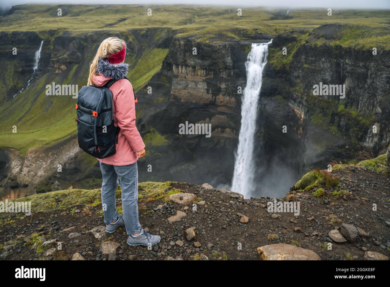 Islande voyage en plein air femme avec sac à dos près de la chute d'eau de  Seljalandsfoss Photo Stock - Alamy