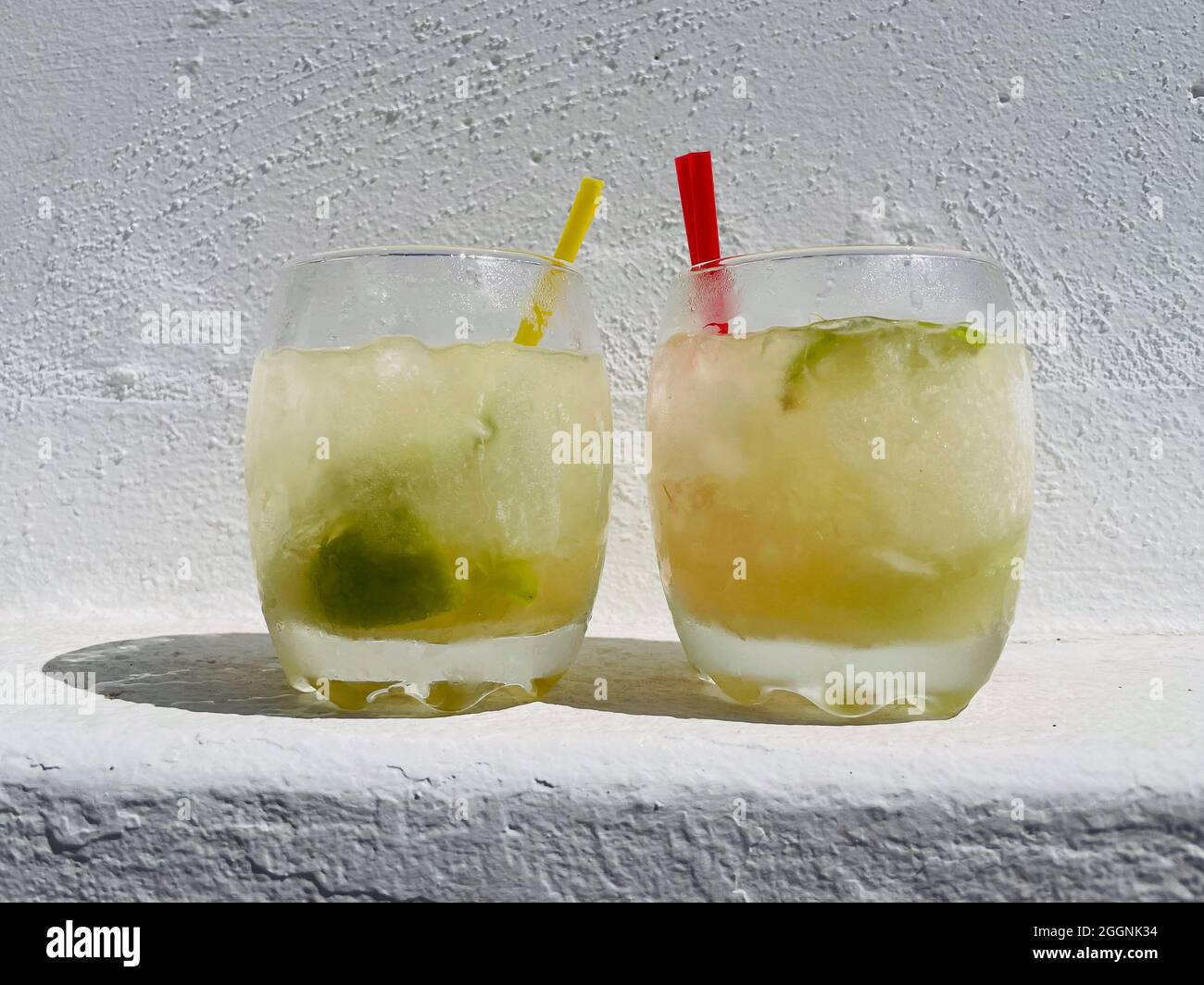 Caipirinha vs Caipirinhas. Boisson rafraîchissante alcoolisée du Brésil avec glace, citron vert, cachaça et sucre. Banque D'Images