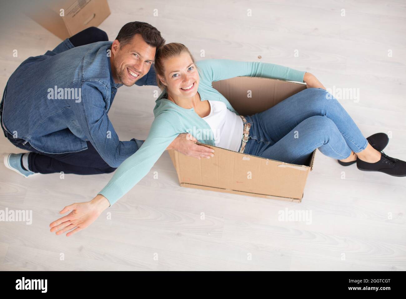 Couple Souriant Dans L Amour Ayant Le Plaisir De Monter A L Interieur D Une Boite En Carton Photo Stock Alamy