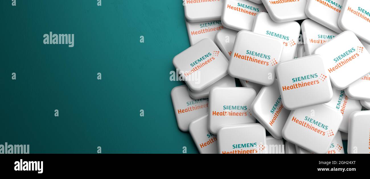 Logos de la société de technologie médicale Siemens Healthineers (membre de DAX 40 à compter de septembre 2021) sur un tas sur une table. Copier l'espace. Format de bannière Web. Banque D'Images