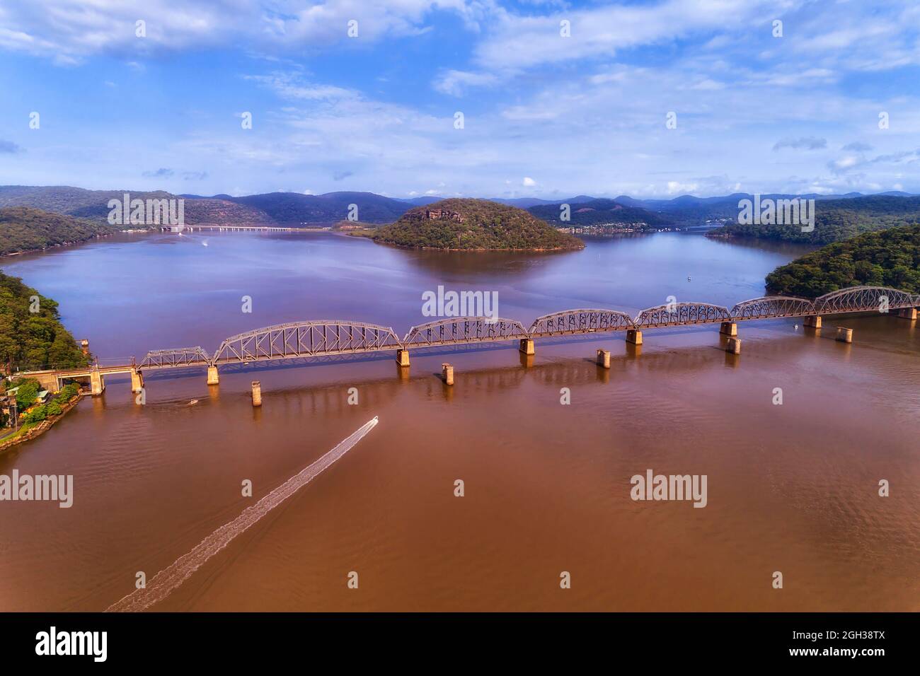 Eaux jaunes de la rivière Hawkesbury près de l'entrée de l'océan Pacifique - village de Brooklyn et pont ferroviaire vers la côte centrale - vue aérienne. Banque D'Images